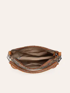 Detailed top view of cork shoulder bag interior showing multi-compartment zipper pockets.