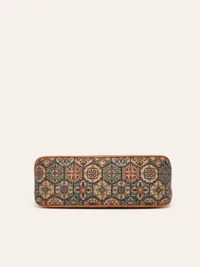 Cork handbag bottom detail, vintage geometric tile pattern print with brown leather trim.