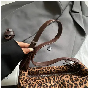 Detailed shot of leopard print shoulder bag strap, premium PU leather and fluffy fabric material.
