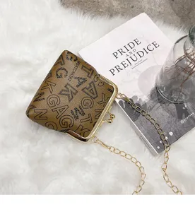 Detailed view of women vintage kiss lock crossbody bag brown leather chain shoulder purse