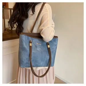 Close-up detail of the stylish large capacity blue shoulder tote bag with brown handles.