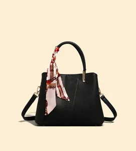 Elegant black handbag for women with stylish silk scarf detail and adjustable shoulder strap.