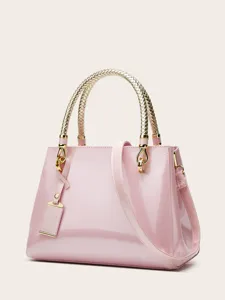 Pink patent leather tote handbag with metallic woven top handle and gold hardware detail.
