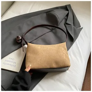 Stylish brown suede underarm shoulder bag for women, elegant daily accessory detail view.