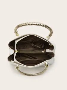 Handbag detail top view showing spacious interior, multiple pockets, and stylish braided handles.