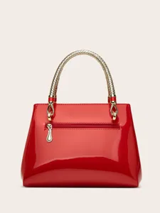Red patent leather handbag detail with golden woven handle and back zipper pocket.