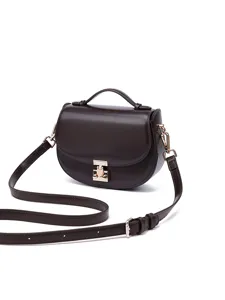 Dark brown leather saddle bag for women with top handle and metal lock cross body design.