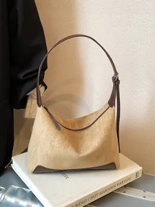 Brown suede shoulder bag for women, elegant hobo underarm handbag with chic leather trim.