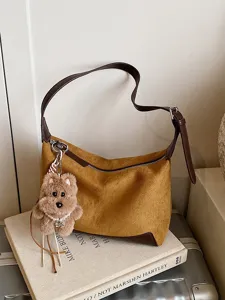 Brown suede shoulder bag with cute plush dog charm, stylish autumn winter underarm handbag.