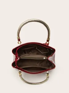 Detailed top view of red patent leather handbag showing interior compartments and gold handles.