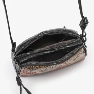 Vintage ethnic style women's crossbody bag with handmade embossed floral design and multi zippers.
