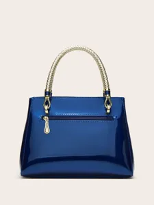 Blue patent leather handbag detail featuring a stylish gold braided top handle and zipper.