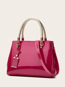 Glossy patent leather handbag with gold braided top handle, elegant tote design for women.