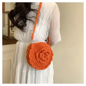Detail shot of the orange crochet round crossbody bag featuring a cute flower design.