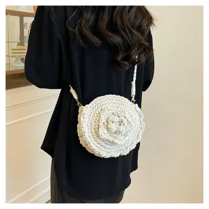 Handmade crochet round crossbody bag with cute 3D flower detail, perfect for beach vacation.
