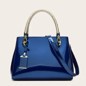 Fashionable blue patent leather women's handbag with gold braided handle and strap.