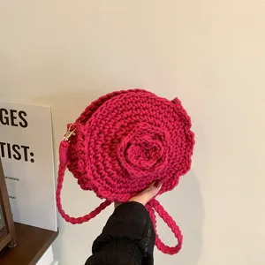 Handcrafted pink crochet crossbody bag with 3d flower motif, perfect for beach vacation.
