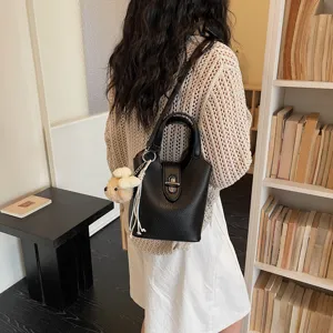 Chic black leather bucket bag for women with cute charm. Ideal for daily commute and style.