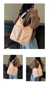 Detail view of casual pink canvas shoulder bag with dual front pockets worn by model.