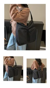 Detail view of the casual black shoulder bag showcasing its multi-pocket design and durable fabric.