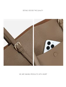 Detailed view of luxury leather tote bag with adjustable strap and chic golden hardware.