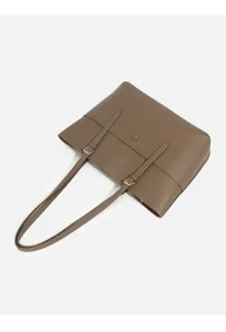 Brown leather tote bag detail view, showing fine shoulder straps and metal buckle design.