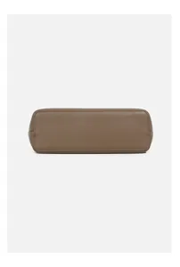 Detailed close-up view of women leather handbag bottom in taupe with fine texture.