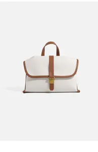 Canvas messenger bag detail, contrast leather trim, top handle, metallic buckle clasp.