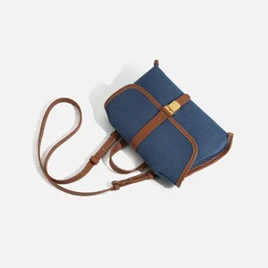 Casual denim messenger bag for women, stylish contrast leather trim and crossbody strap.