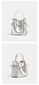 Metallic silver bucket bag detail showing stylish side ribbon ties and durable top handle.