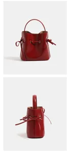 Red bucket bag detail showing smooth glossy finish, metal eyelets and delicate drawstring bows.