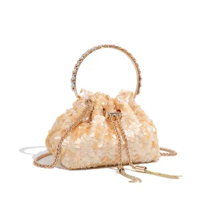Detail view of the sparkling sequin bucket bag featuring a chic metal ring handle and chain strap.