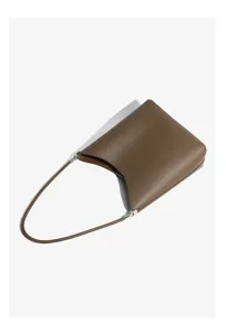 Minimalist brown leather shoulder bag detail showcasing premium curved texture and hardware.