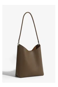 Brown leather shoulder bag detail, stylish bucket tote with silver hardware for daily commute.