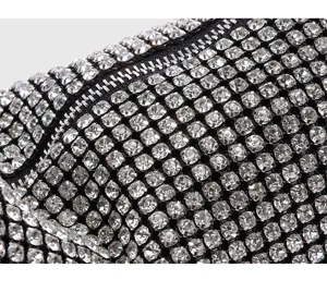Handcrafted rhinestone crystal evening bag detail, sparkling diamond shoulder armpit purse.
