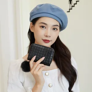 Women woven short coin purse with cute fluffy ball pendant, stylish compact daily clutch bag.