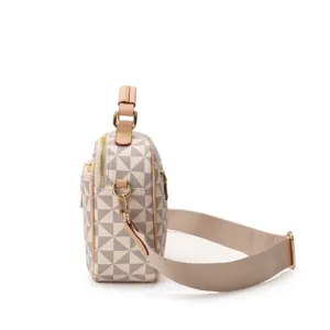 Detailed side view of women checkered crossbody bag with wide strap and gold hardware.