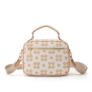 Chic white crossbody bag with stylish spade pattern, top handle, and durable gold hardware.