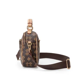 Detailed view of women's brown monogram crossbody shoulder bag with adjustable strap and gold hardware.