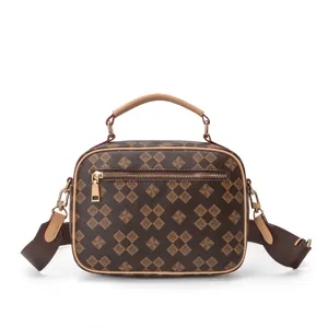 Detailed view of women's fashion top-handle crossbody bag with luxury monogram pattern.