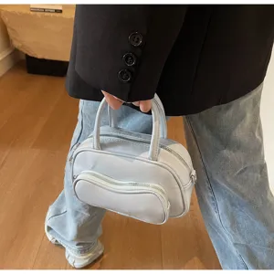 Chic light blue top handle crossbody bag for women, stylish mini pillow shoulder bag daily use.