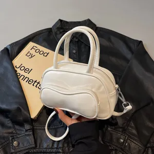 White pillow shoulder bag for women, stylish crossbody handbag with top handles and strap.