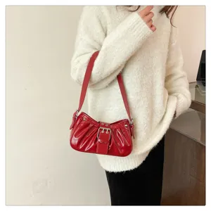 Red patent leather pleated shoulder bag for women, retro motorcycle style handbag with buckle.