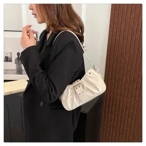 Cream white pleated shoulder bag with metal buckle, stylish retro baguette bag for women.
