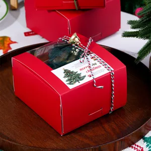 Red Christmas gift paper box with transparent window, festive packaging for holiday presents.