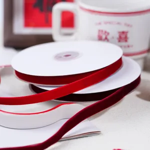 Red velvet ribbon roll for DIY gift wrapping, Christmas and New Year holiday box decoration.