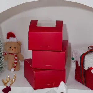 Red Christmas gift box with clear window, festive paper packaging for holiday gifts