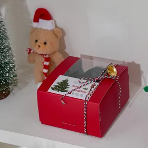Red Christmas window gift box detail view with festive decorative ribbon and holiday card.