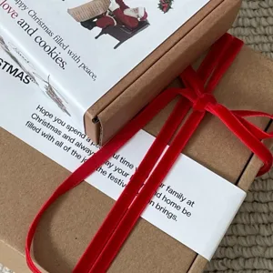 Red velvet ribbon and Christmas gift packaging boxes set for holiday party decor and gift wrapping.