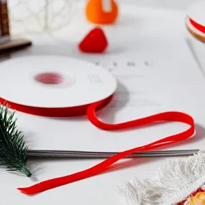 Red velvet ribbon detail shot, soft texture for DIY gift wrapping and Christmas packaging.